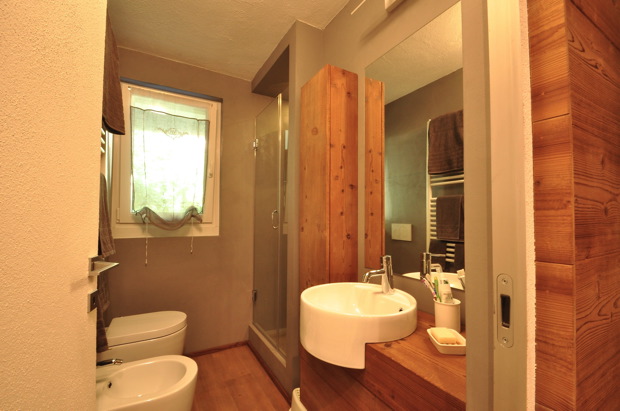 renovated bathroom with shower and resin wall covering